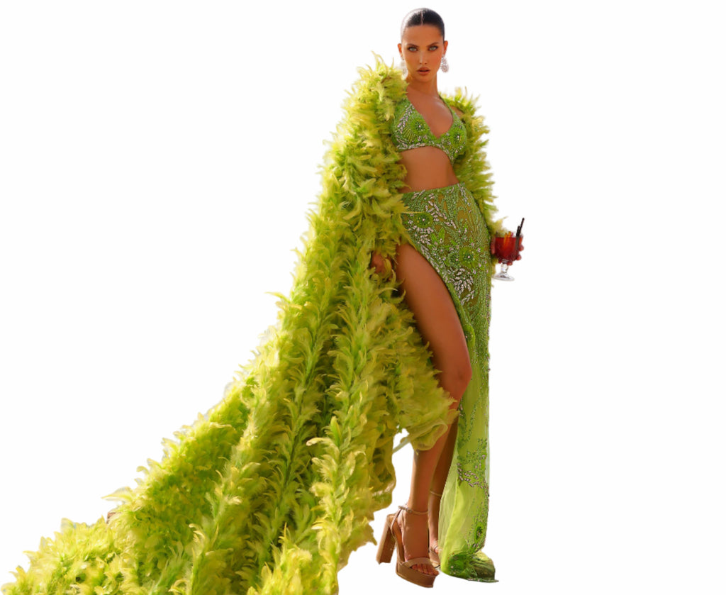 Woman in a green outfit with a long green fabric 