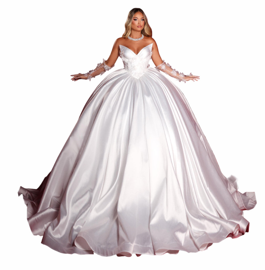 Woman in a white wedding dress standing in front of red curtains