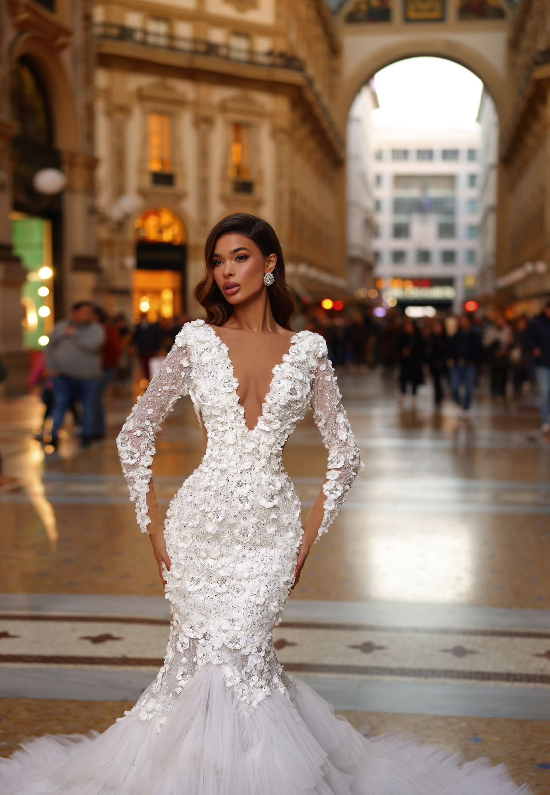 Woman in a white wedding dress with long sleeves in an urban setting