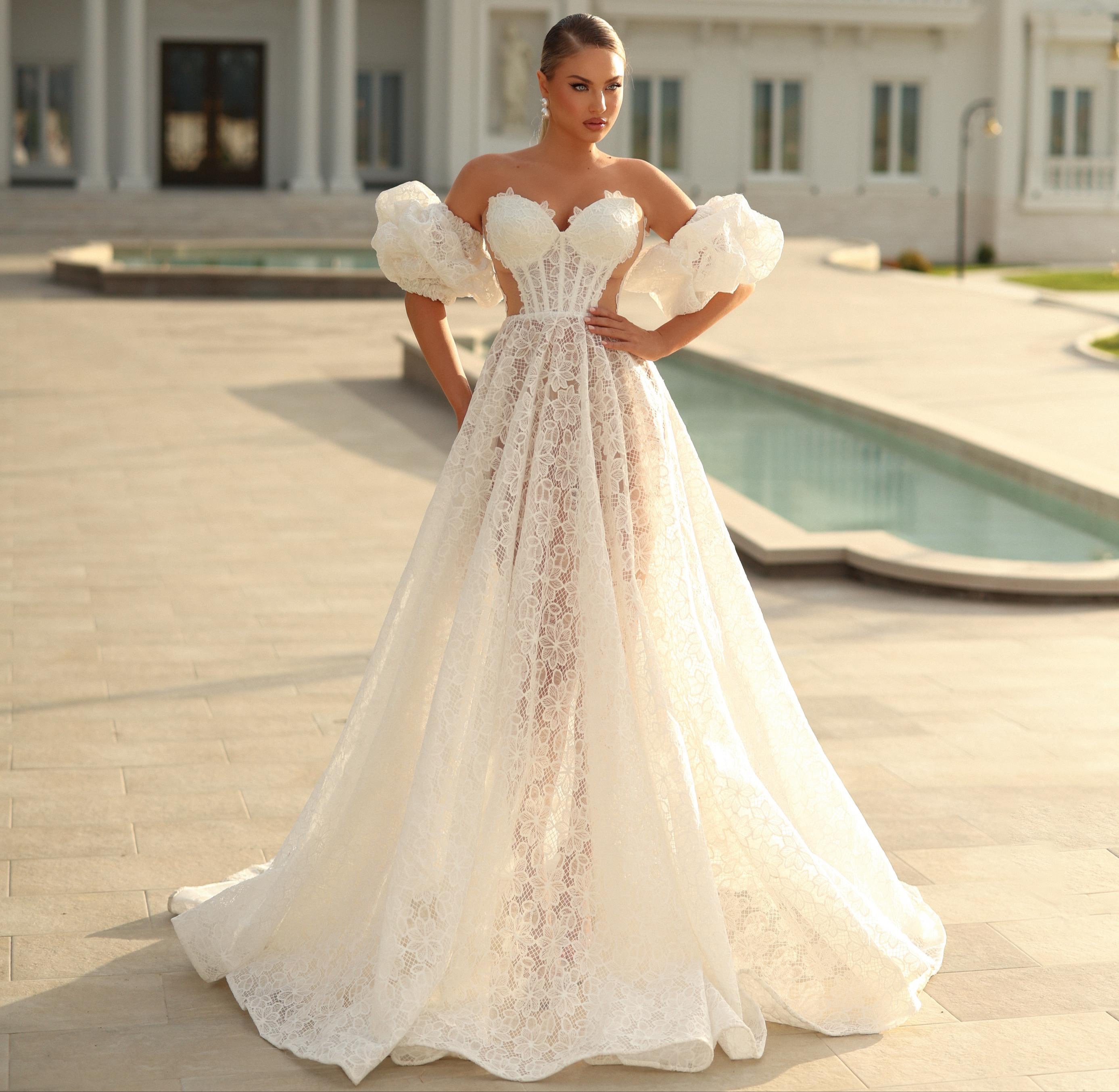 Woman in a white wedding dress standing in front of a large building with columns.