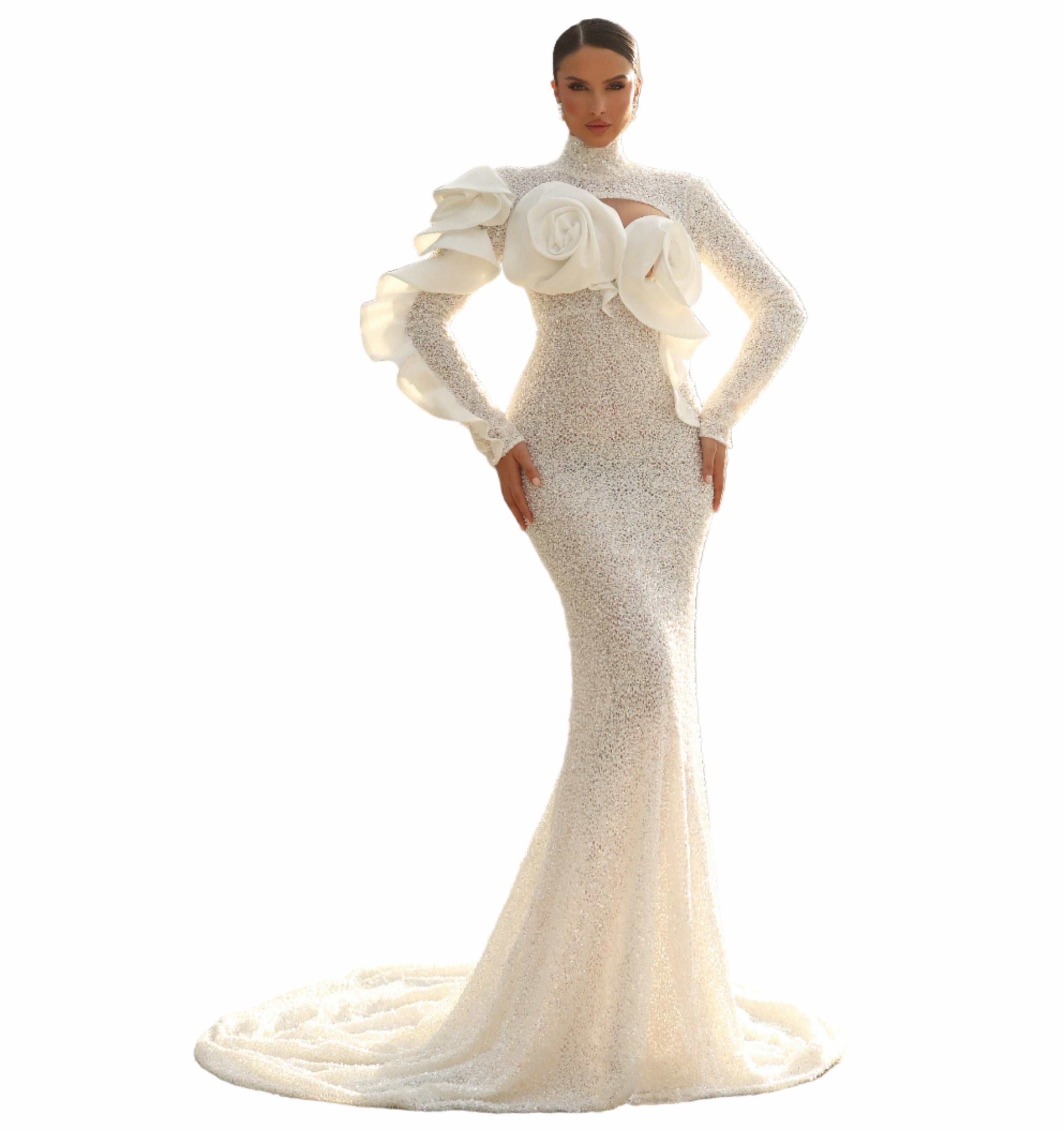 Woman in a white evening gown with floral details standing