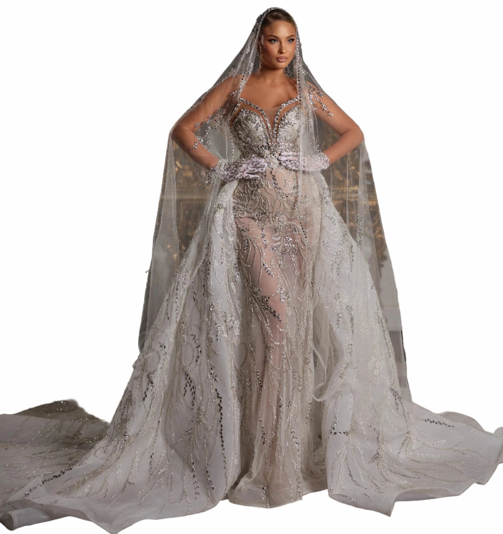 Woman in a sparkling silver wedding dress with a long train 