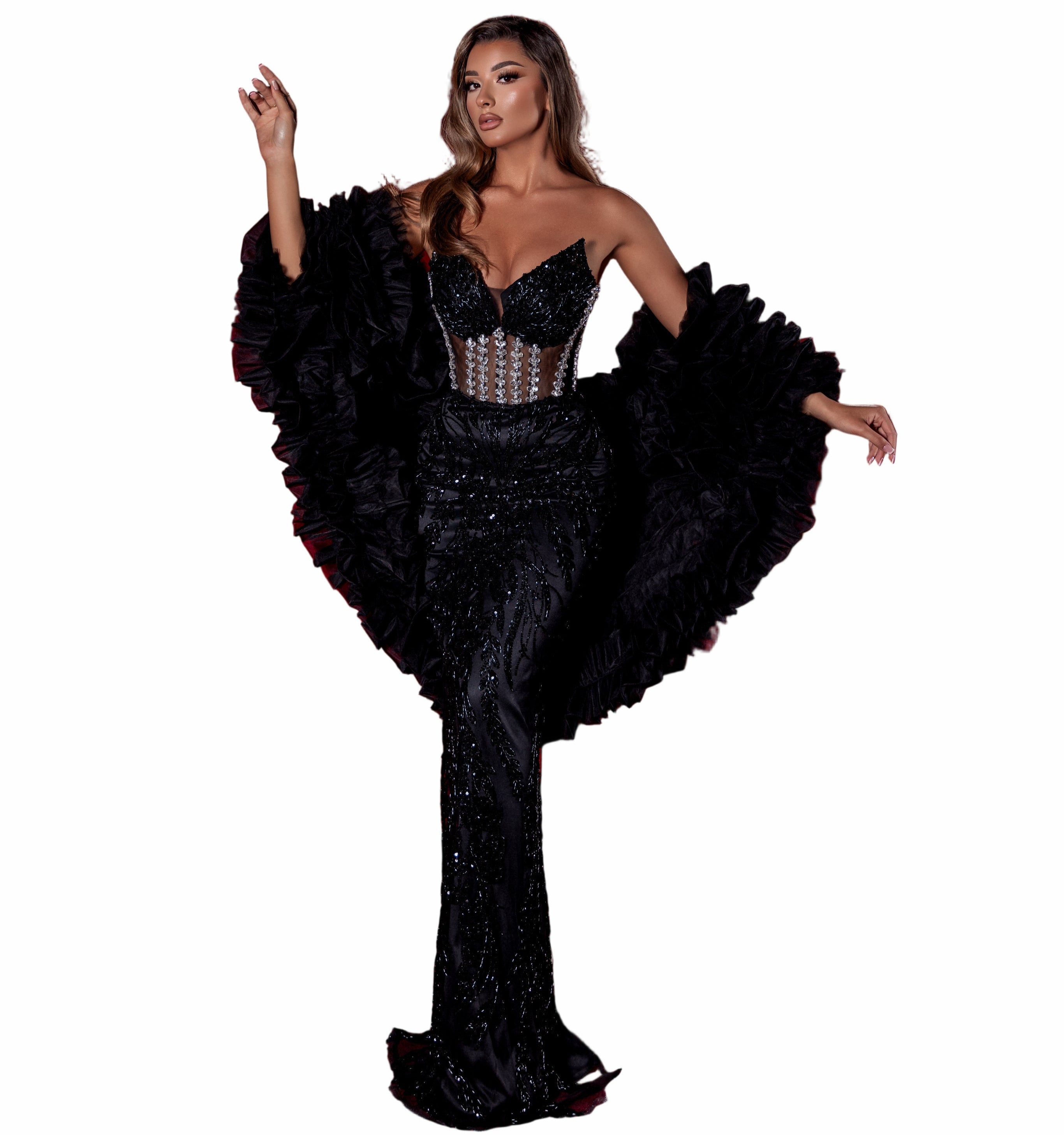 Woman in a black evening gown with sequin details in a theater setting