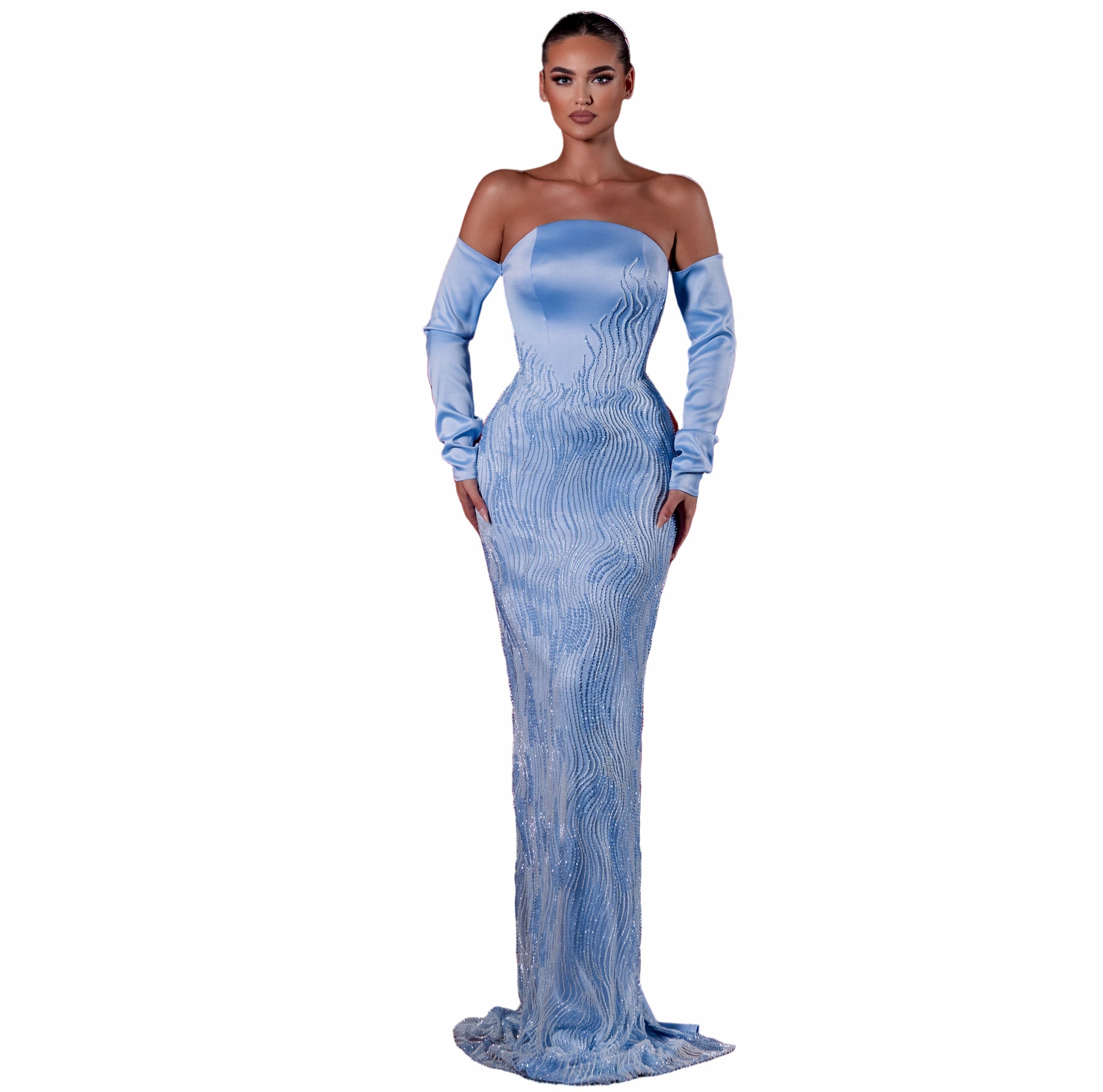 Woman in a blue evening gown standing in an empty theater with red seats.